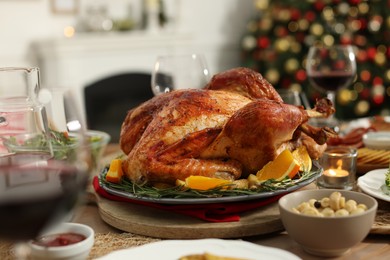 Photo of Festive dinner with delicious baked turkey served on table indoors. Christmas celebration