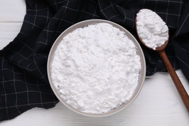 Photo of Bowl and spoon of starch on white wooden table, top view