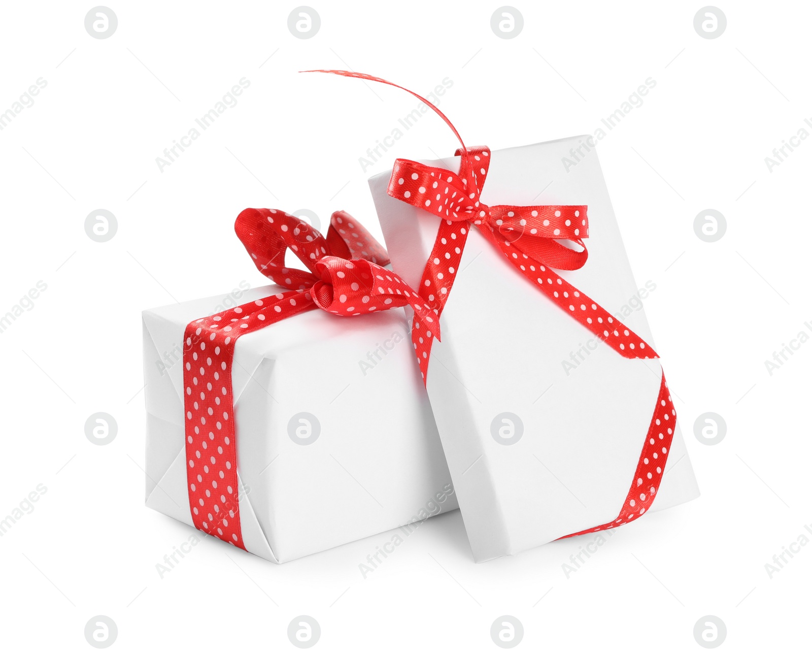 Photo of Christmas gift boxes decorated with red bows on white background