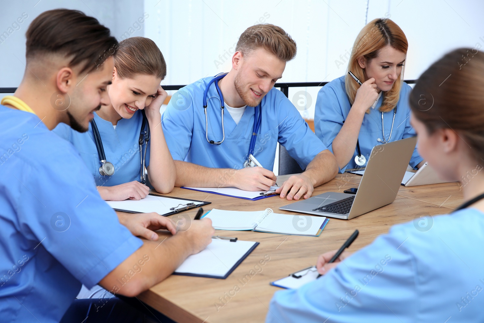 Photo of Medical students in uniforms studying at university