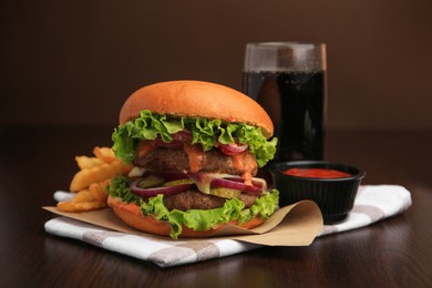 Photo of Tasty burger with vegetables, patties and lettuce served on wooden table