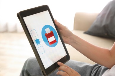 Woman voting online via tablet indoors, closeup