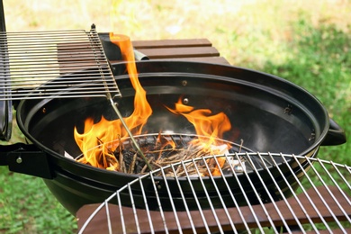 Photo of Modern barbecue grill with fire flames outdoors