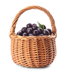 Photo of Fresh acai berries in wicker basket isolated on white