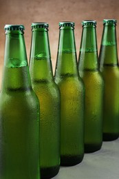 Many bottles of beer on white table, closeup