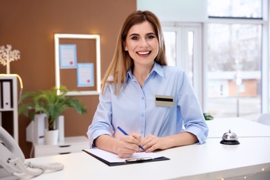 Photo of Female receptionist at hotel check-in counter