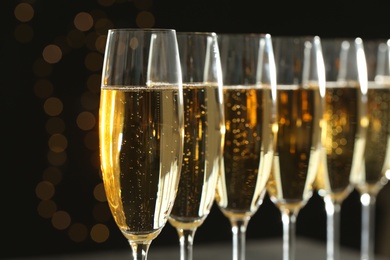 Many glasses of champagne on blurred background, closeup