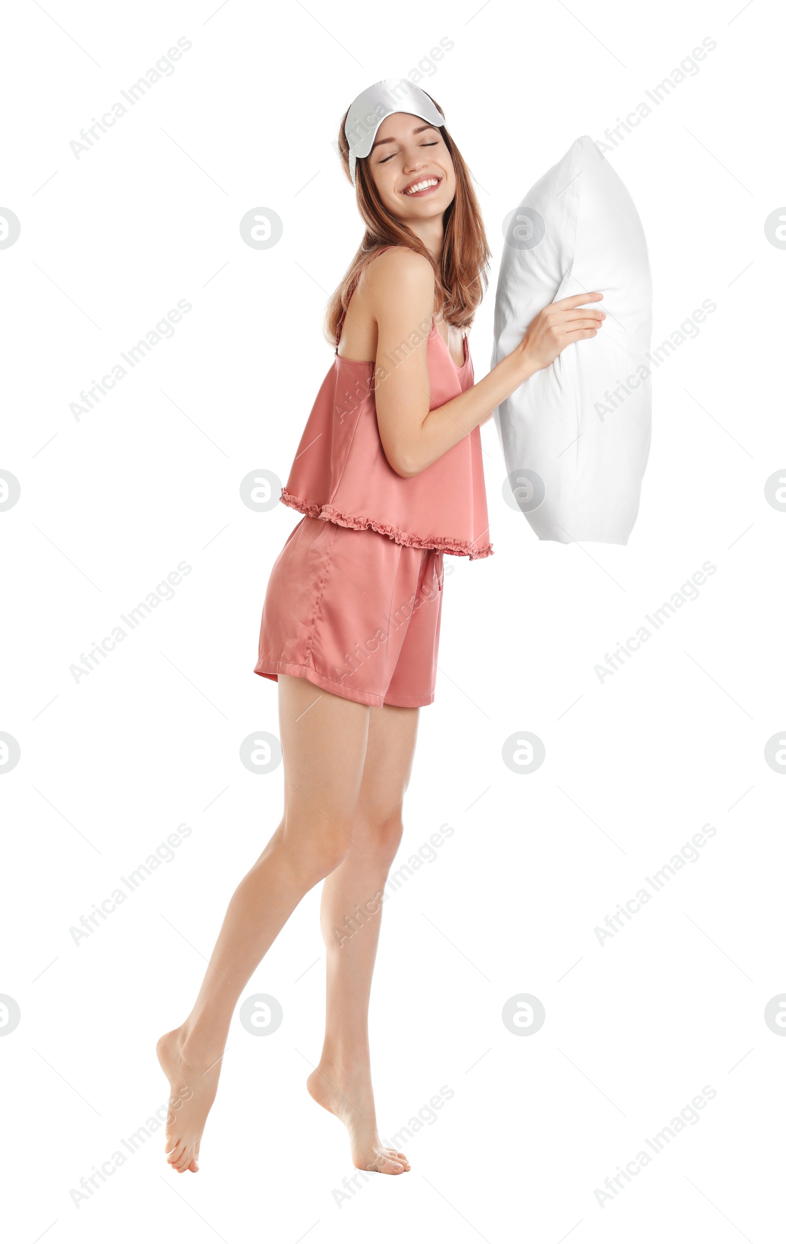 Photo of Beautiful woman with pillow and sleep mask on white background. Bedtime