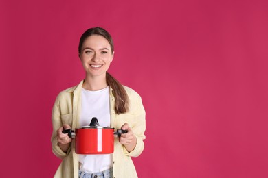 Photo of Happy woman with pot on crimson background, space for text