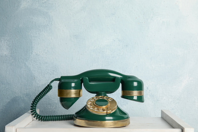 Photo of Vintage corded phone on white wooden table