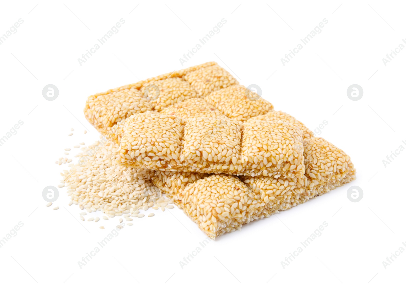 Photo of Delicious sweet kozinaki bars and sesame seeds on white background