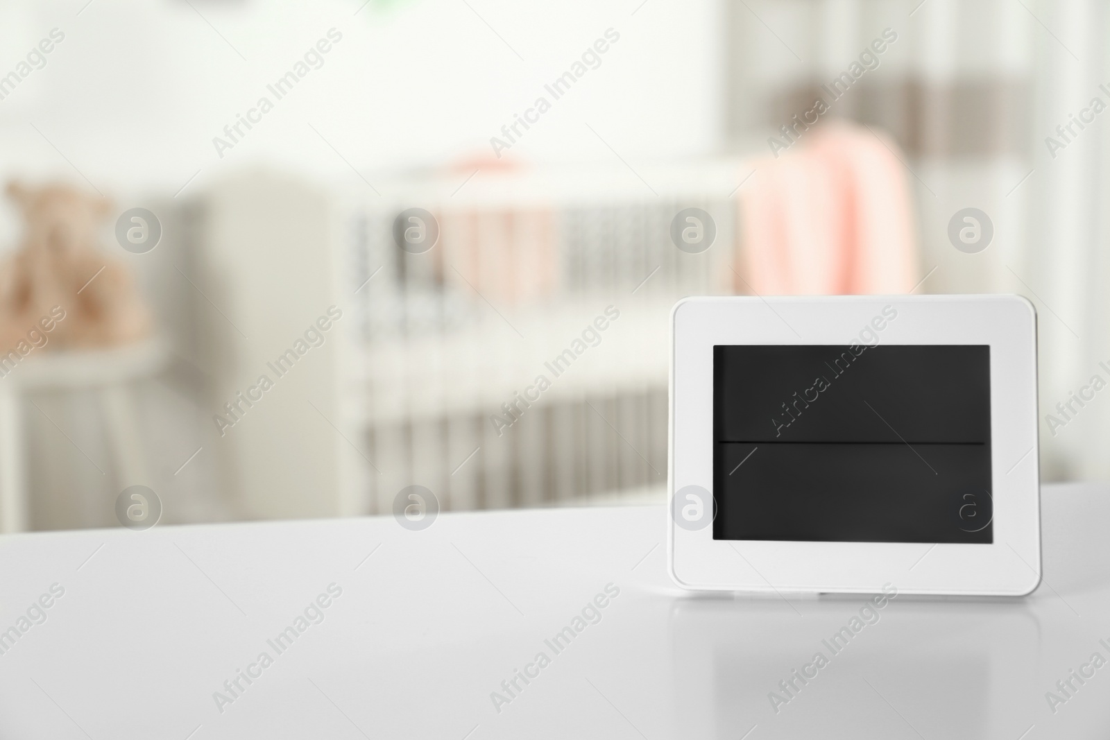 Photo of Digital temperature and humidity control in baby room interior. Space for text