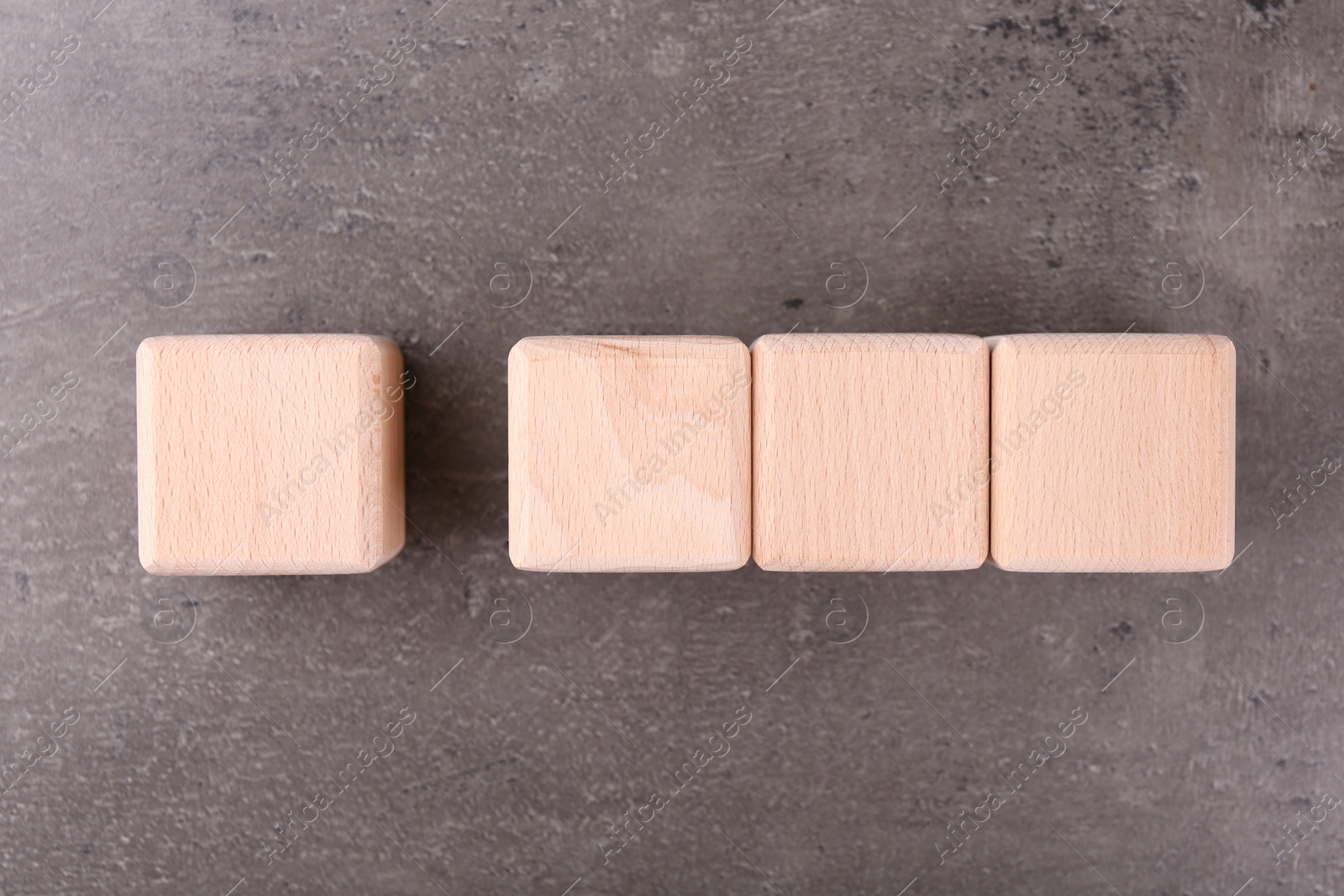 Photo of Wooden cubes with check mark and abbreviation ISO on grey textured table, flat lay