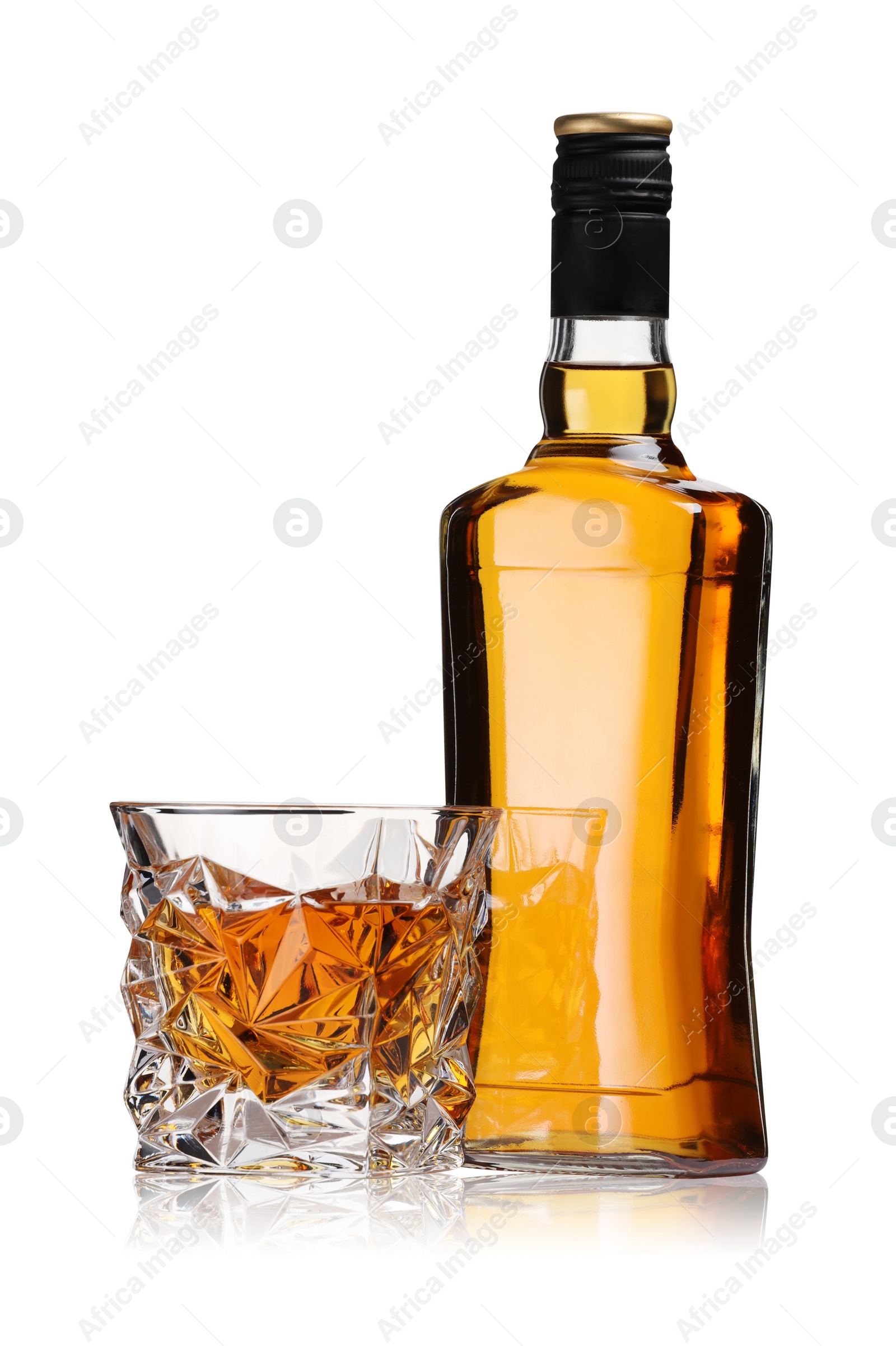 Photo of Glass and bottle of whiskey isolated on white