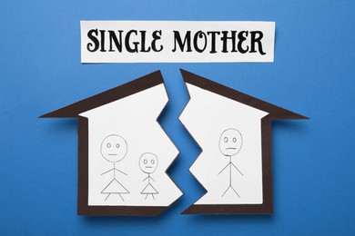 Being single mother after divorce concept. Paper cutouts demonstrating broken family on blue background, flat lay