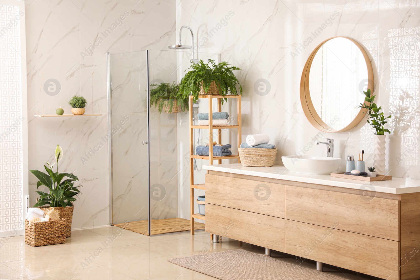 Photo of Stylish bathroom interior with countertop, shower stall and houseplants. Design idea