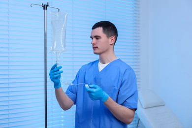 Photo of Nurse setting up IV drip in hospital