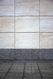 Photo of View on urban tiled wall and pavement