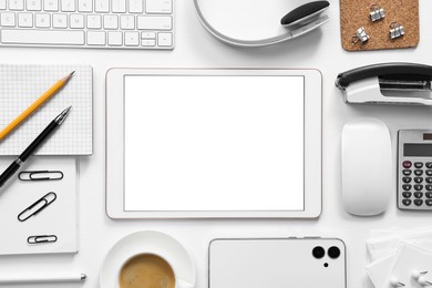 Photo of Flat lay composition with modern tablet on white background. Space for text