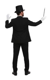 Photo of Magician in top hat holding wand on white background, back view