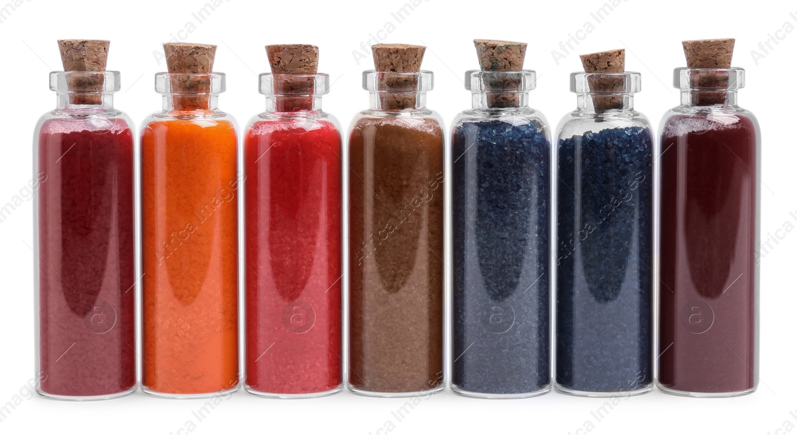 Photo of Glass bottles of different food coloring isolated on white