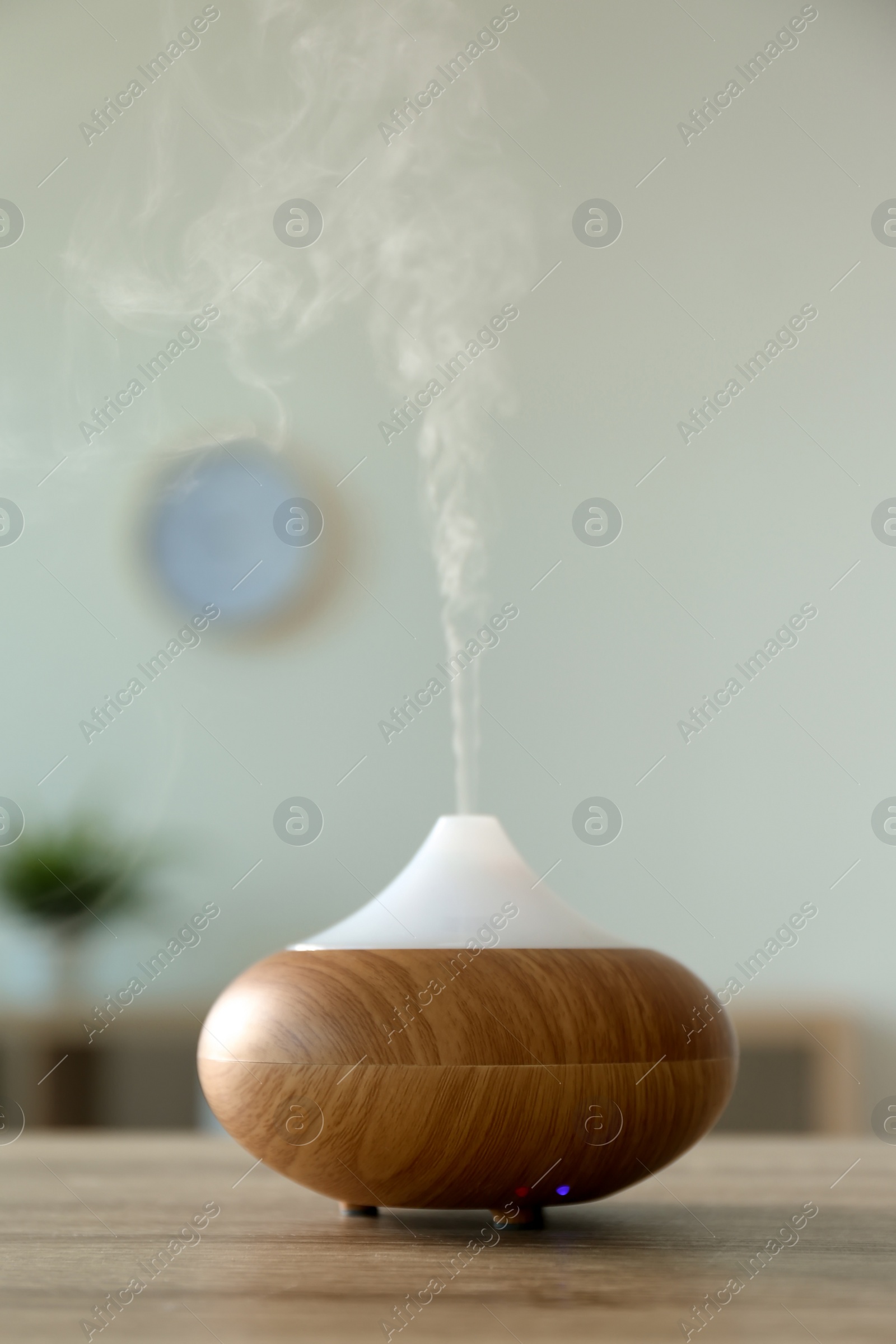 Photo of Modern aroma lamp on table in room