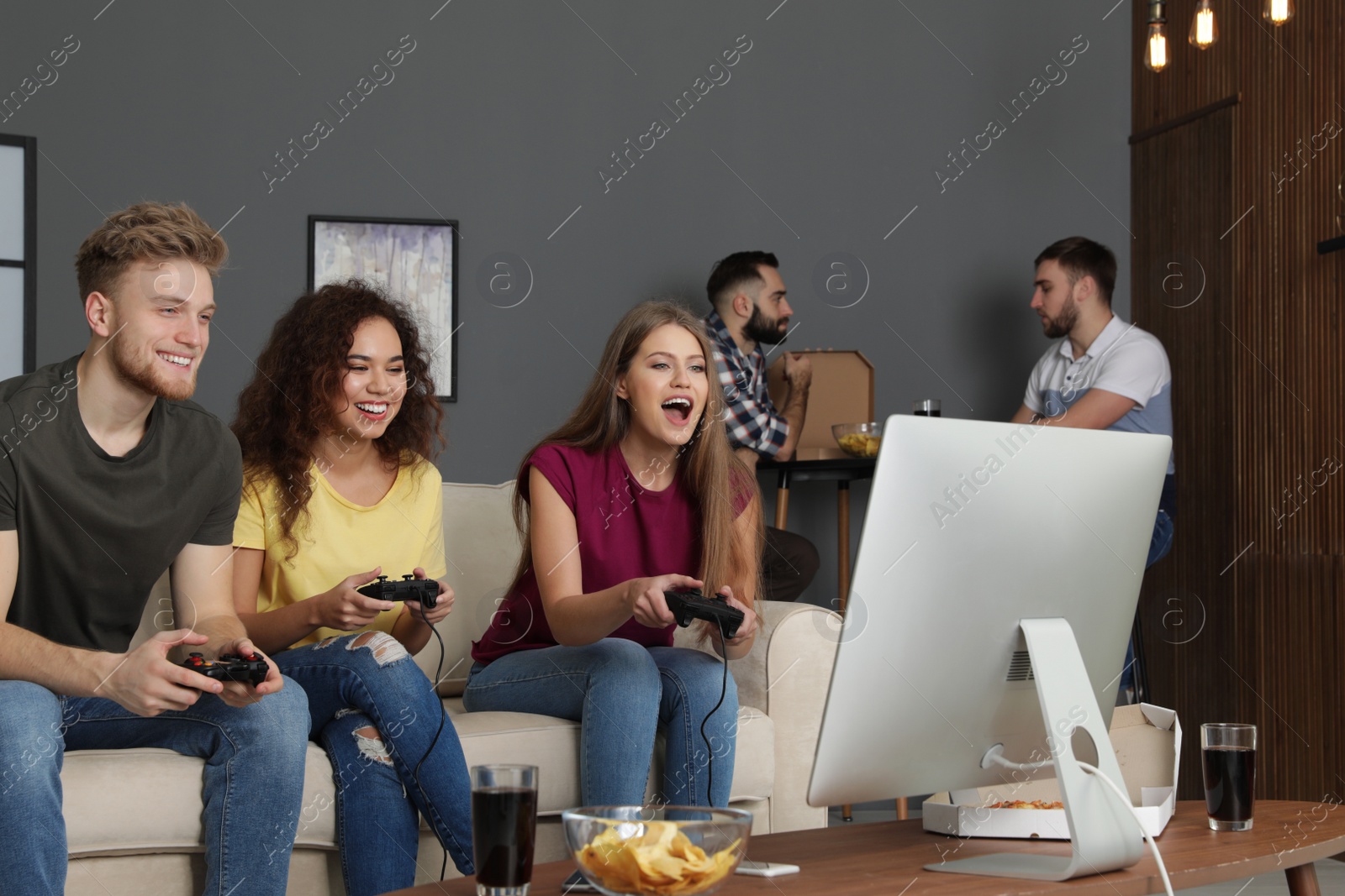 Photo of Emotional friends playing video games at home