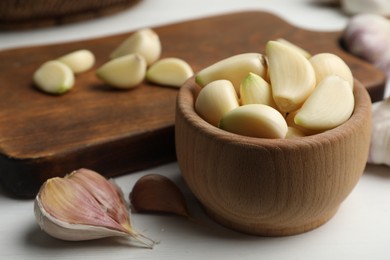 Photo of Fresh organic garlic on white table, closeup