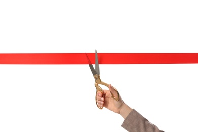 Photo of Woman in office suit cutting red ribbon isolated on white, closeup