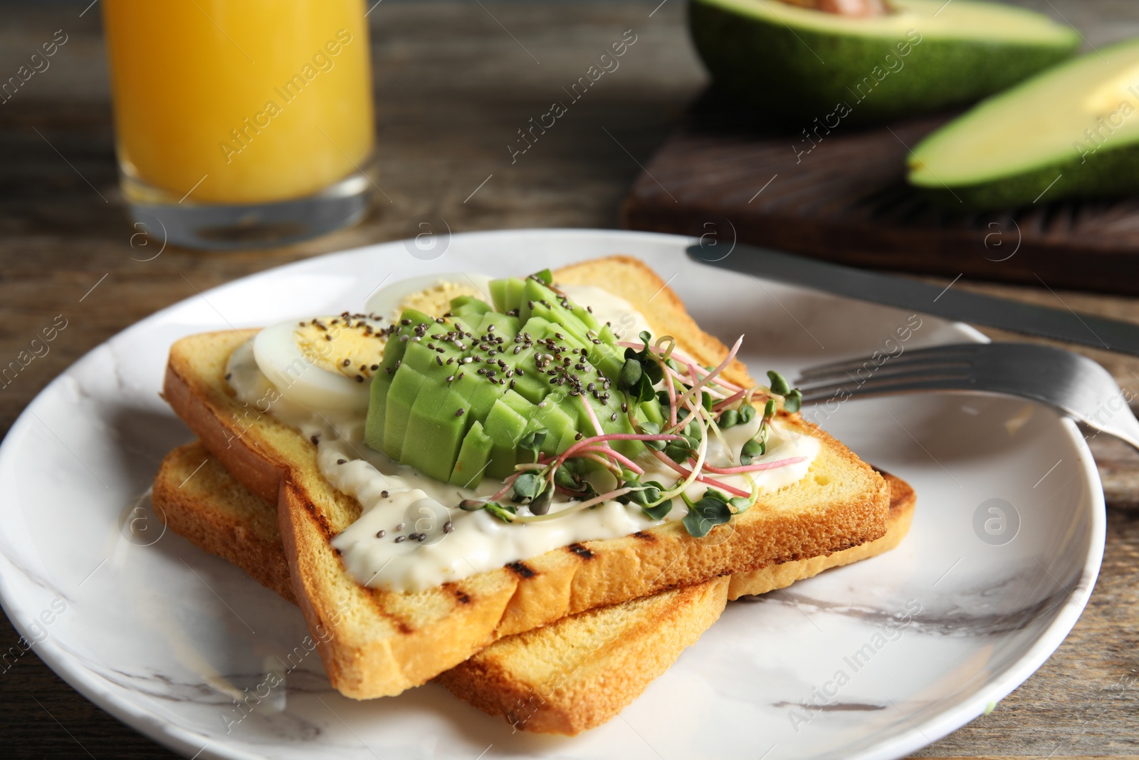 Photo of Tasty toast with avocado, sprouts and chia seeds on plate