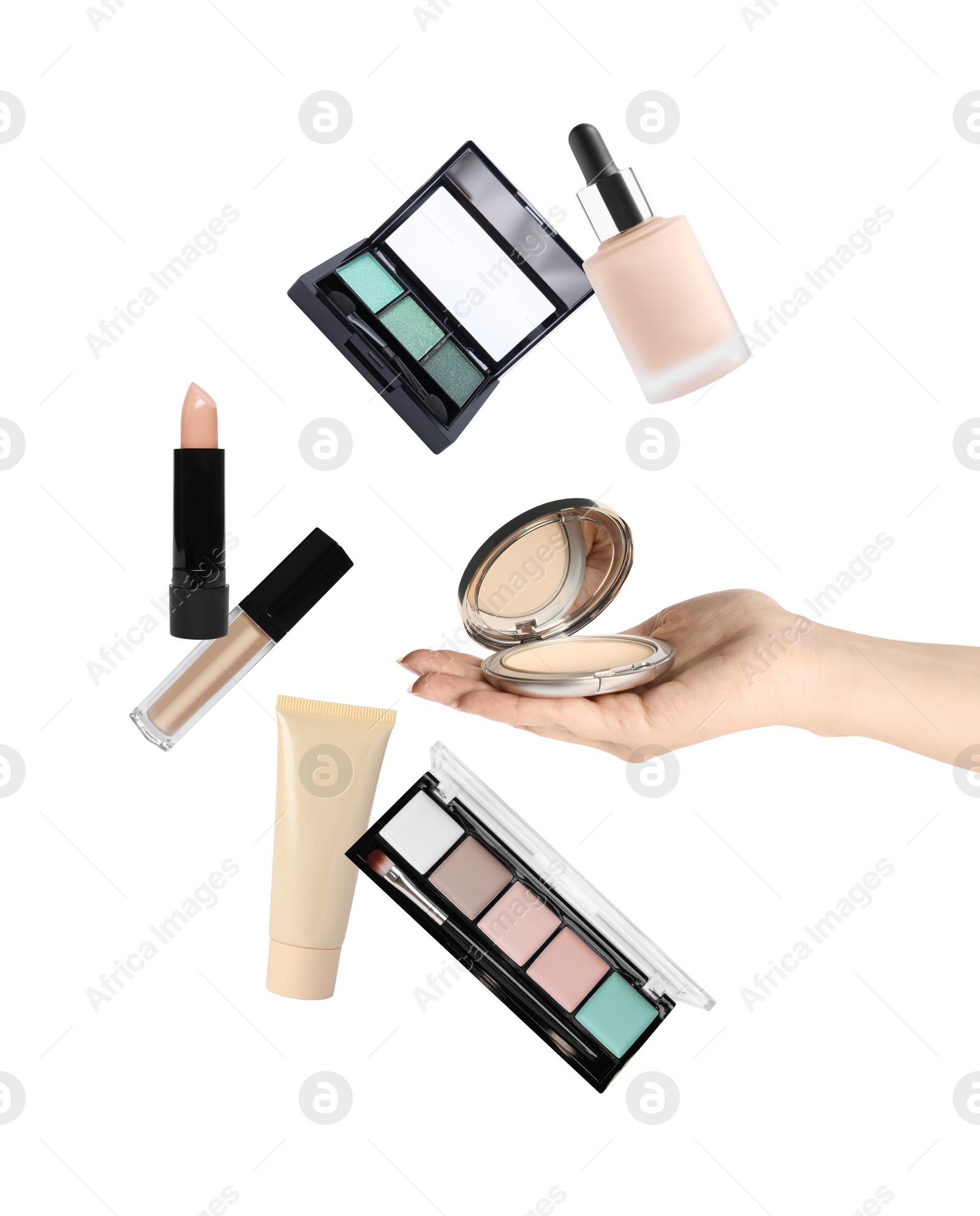 Image of Woman holding powder on white background, closeup. Other makeup products flying around her hand