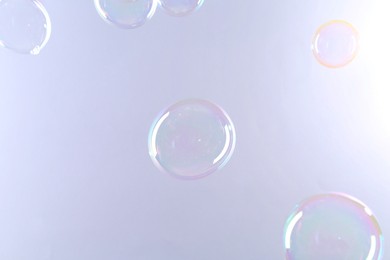 Photo of Beautiful transparent soap bubbles on gray background