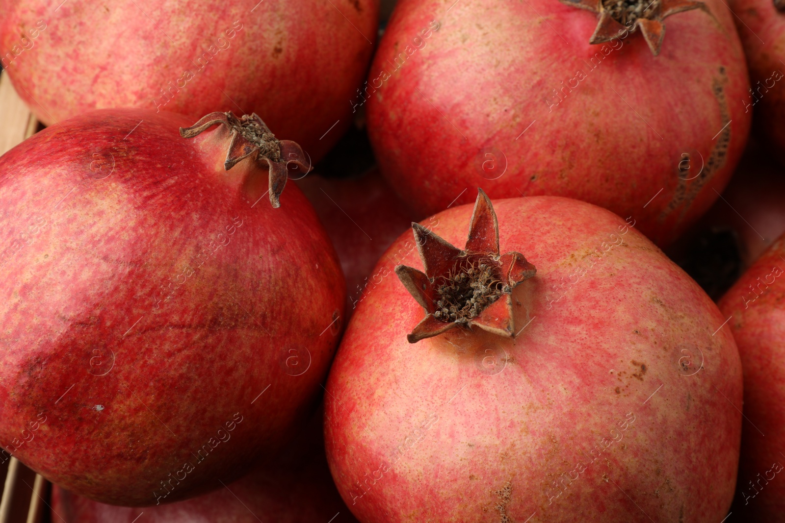 Photo of Many fresh ripe pomegranates as background, closeup