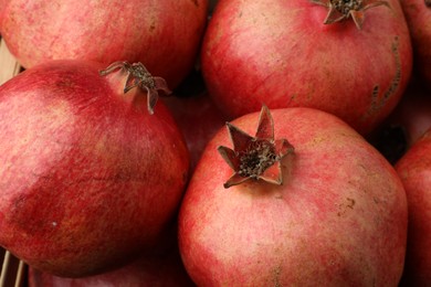 Photo of Many fresh ripe pomegranates as background, closeup