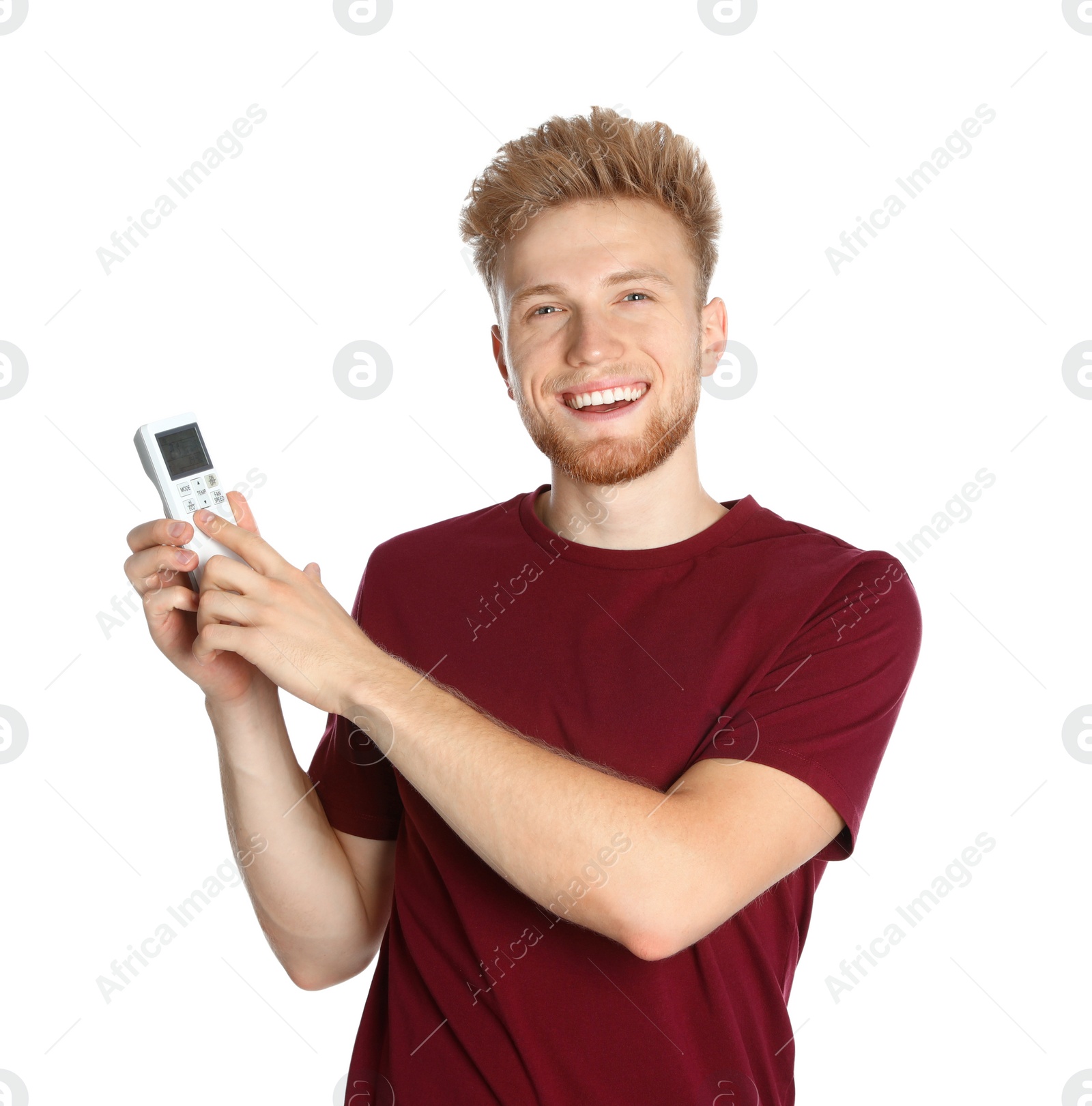 Photo of Young man with air conditioner remote on white background