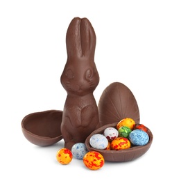 Photo of Chocolate Easter bunny and eggs on white background