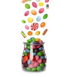 Image of Different delicious candies falling into glass jar on white background 