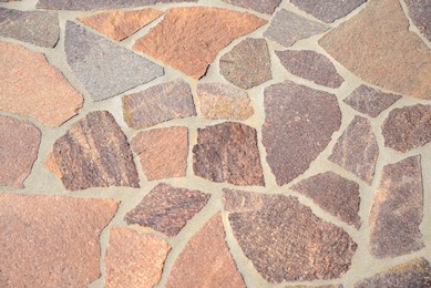 Photo of Beautiful pavement with stone fragments as background, top view