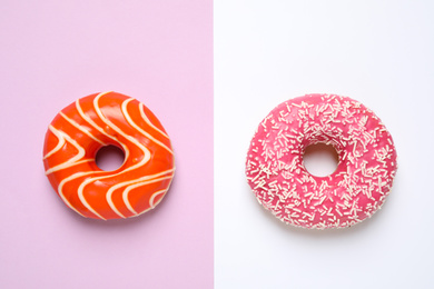 Delicious glazed donuts on color background, flat lay