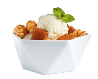 Photo of Bowl of delicious ice cream with caramel candies, popcorn and mint on white background