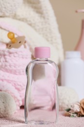 Photo of Bottle of baby cosmetic product on pink towel