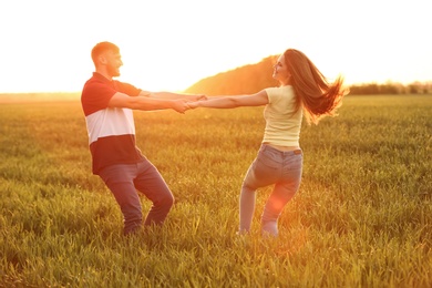 Photo of Happy young couple in green field on sunny spring day