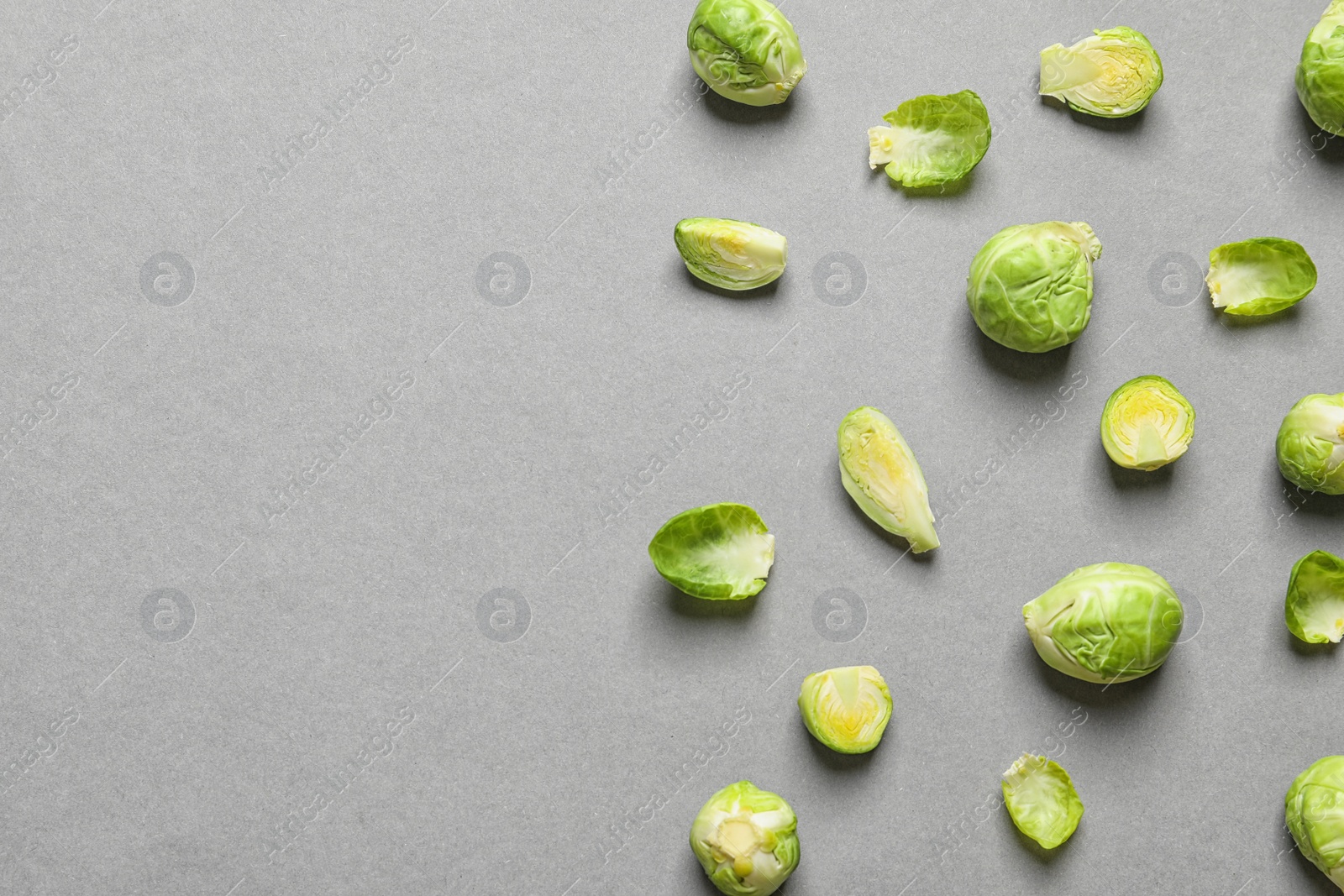 Photo of Tasty fresh Brussels sprouts on grey background, top view with space for text