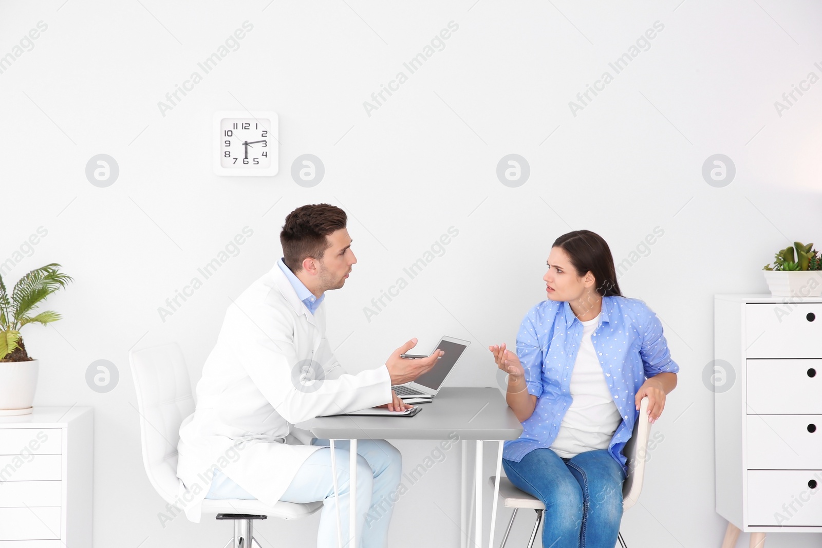 Photo of Depressed young woman having appointment with psychologist in office