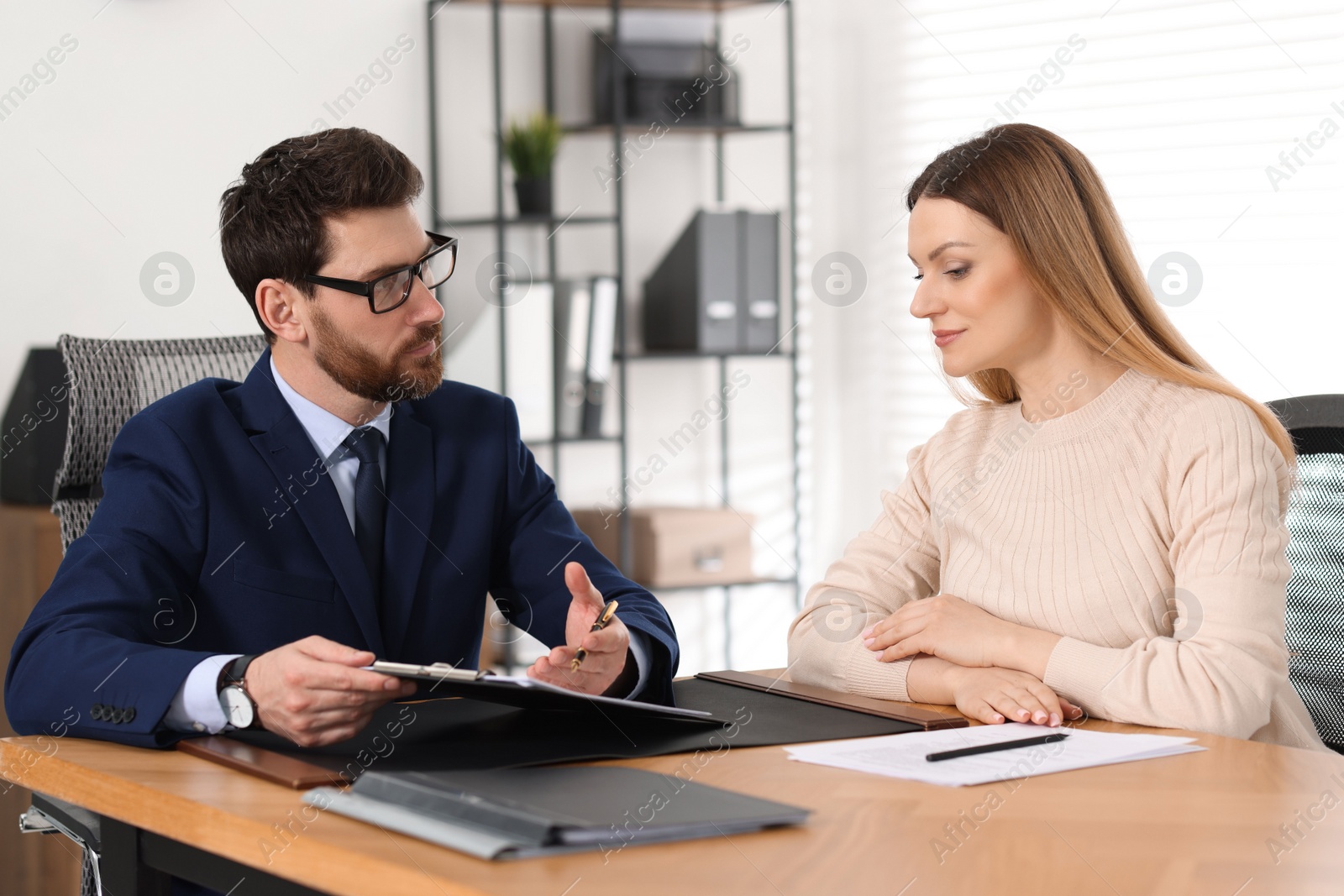 Photo of Woman having meeting with lawyer in office