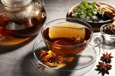 Photo of Aromatic tea with anise stars on light grey table