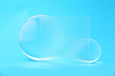 Photo of Transparent glass balls on light blue background