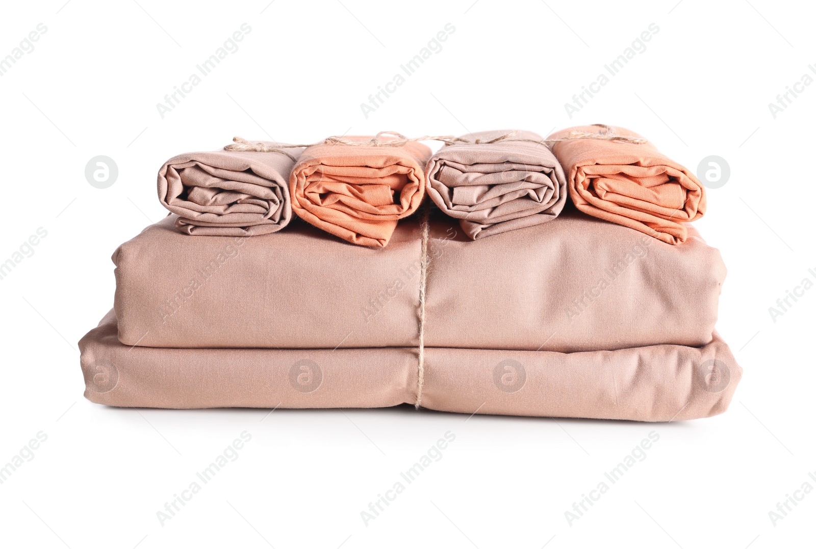 Photo of Stack of clean bed sheets tied with rope isolated on white