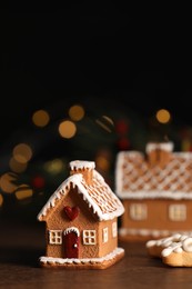 Beautiful gingerbread houses with icing on wooden table