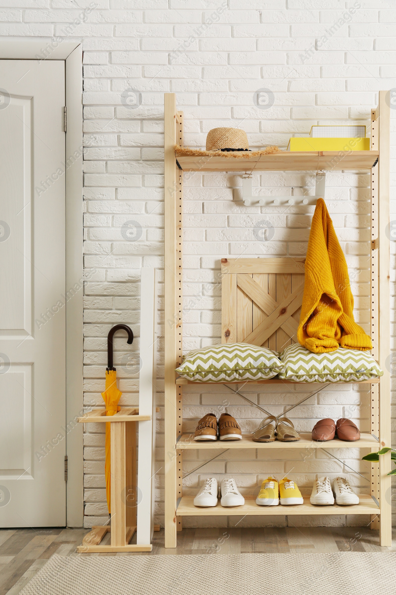 Photo of Cozy hallway interior with wooden shelving unit. Stylish design idea